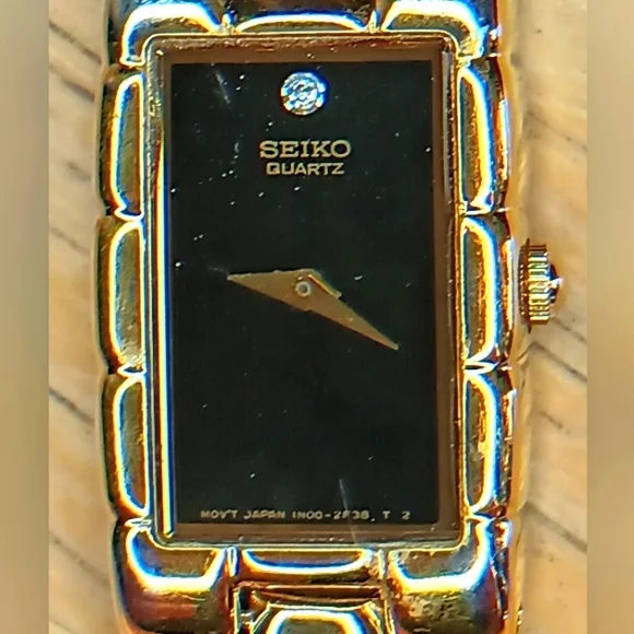 Seiko Ladies Black dial, 2 hand movement gold case and bracelet w/diamond at 12 - Picture 1 of 10
